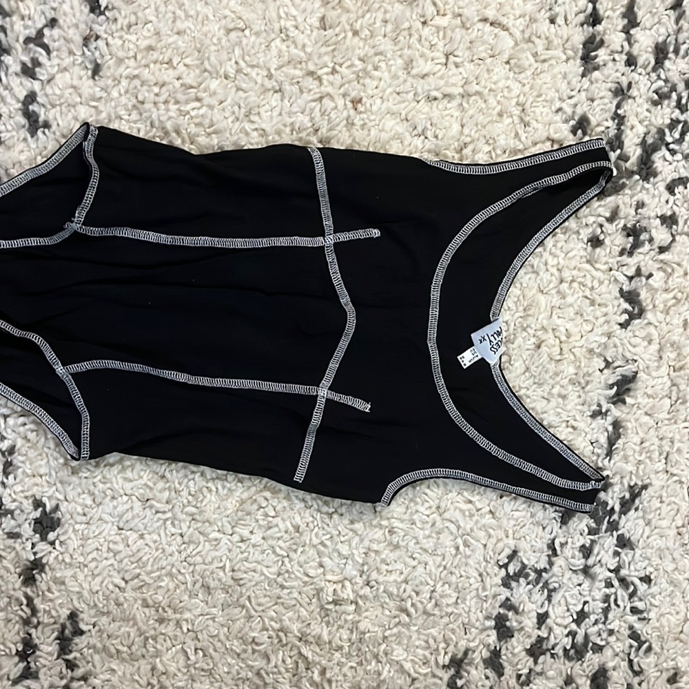 Black body suit with white stitching